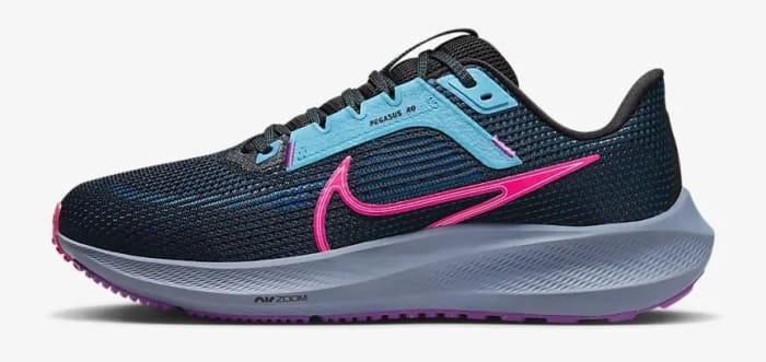 Side view of a black and pink Nike running shoe.